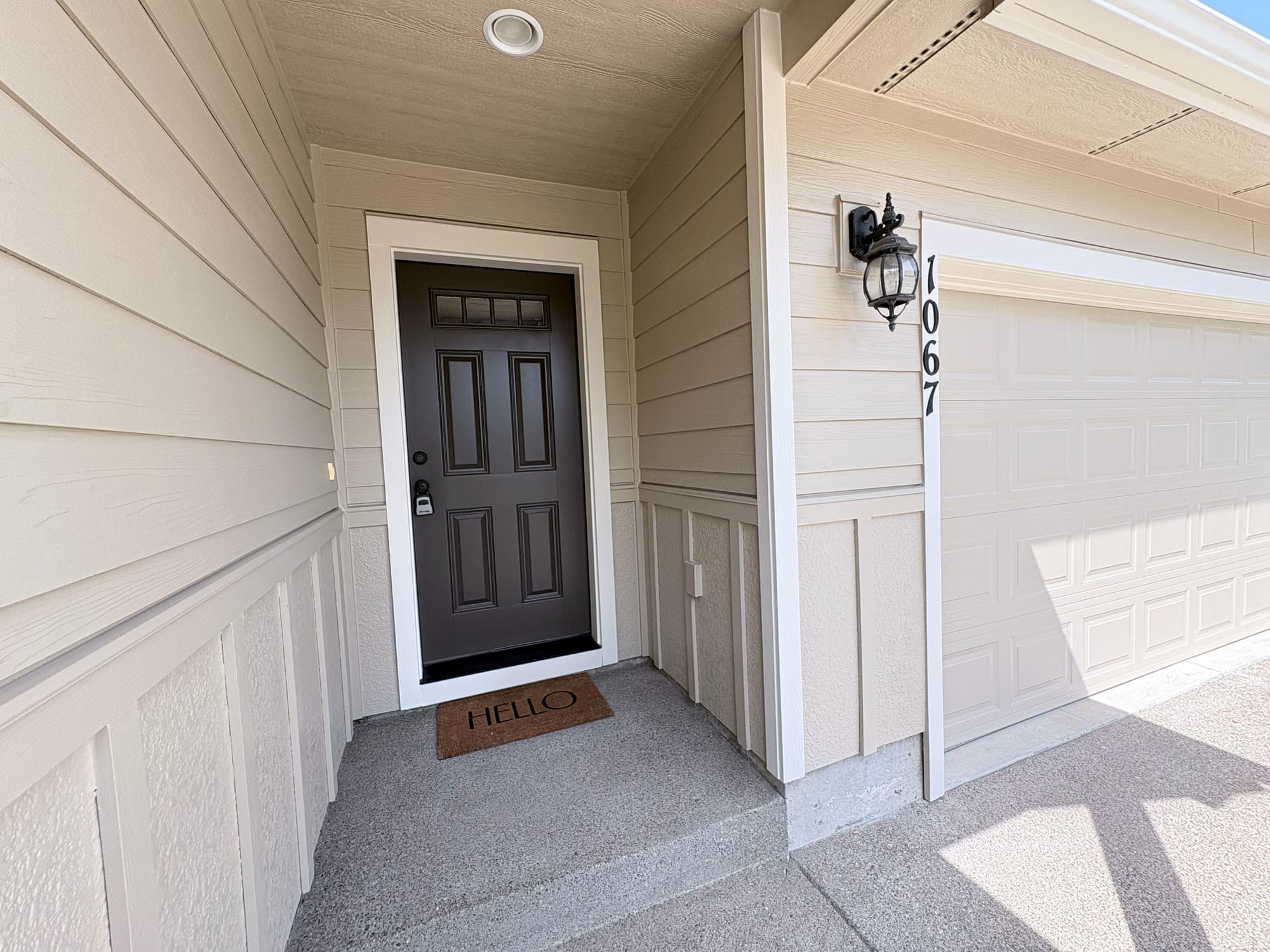 Front entry of a Double K managed home, with a welcome mat at the door